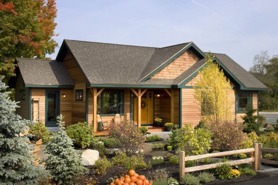 The modular home, which was built in 31 days, is sited and graded to direct surface sheet drainage to the rain garden for infiltration.
