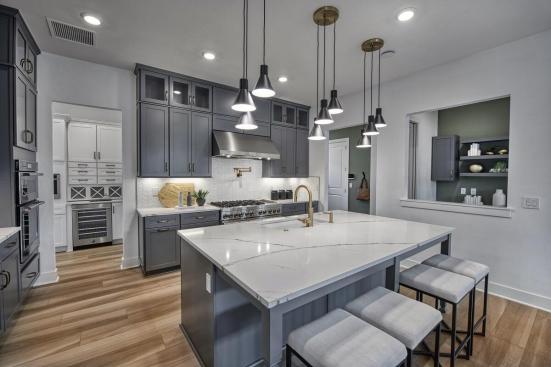 The main kitchen offers space to entertain with open spaces, minimalist features, and a simple color palette.