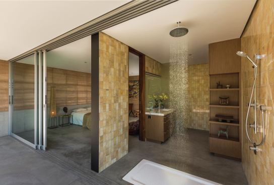 The bathrooms’ material palette includes white onyx, honey onyx, and mother of pearl.