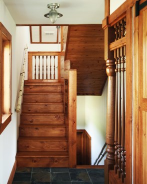 Rustic touches like birch trunk stairway railings give the family house a handmade feel. 