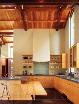 A ceiling-height window orients the view from this kitchen toward a nearby redwood grove.
