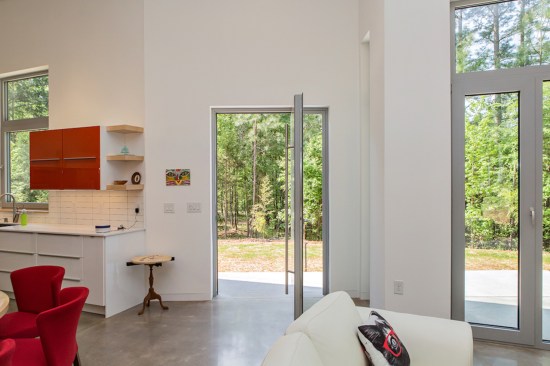 The steel, pivoting front door has no impact on the interior space when open.