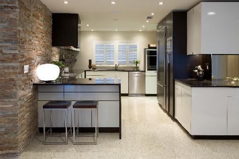 The ledgestone wall offers a pleasing contrast with the kitchen's basic color palette and varied textrues. Nearly all of the home's original terrazzo floors were kept.