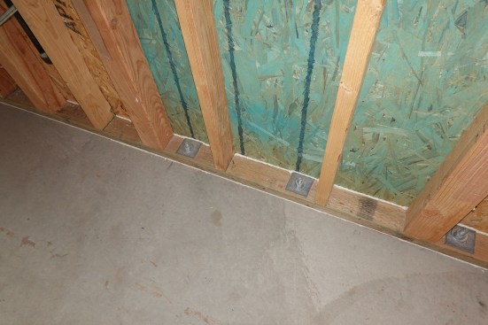 Good air-sealing becomes critical when walls are vapor-closed to the outside. Here, a builder did it right, as they have caulked the sheathing joint to the wall plate and the plate to the floor. (Yes, you need to do both.)
