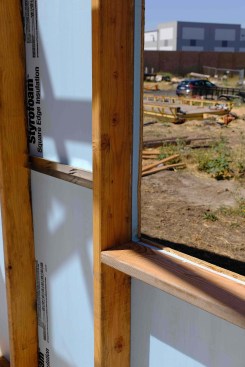 Here, foam insulation has been applied directly to the studs, with sheathing applied outboard of that.