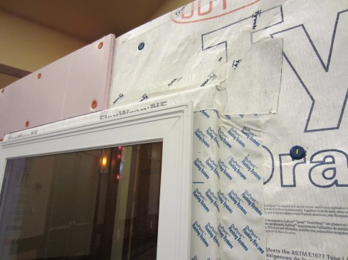 In this example, the window buck, window, drainable housewrap, and flashing have been installed prior to the application of the insulating foam. Always use a drainable wrap anytime you apply foam over the wrap. It’s important to carefully review window manufacturer installation instructions and warranties. Some window companies, for example, require “effective engineered drainage systems” for the warranty to apply.