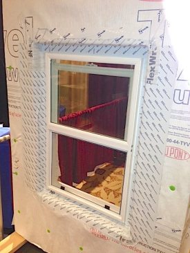 Here, the window has been applied directly to the wall before the application of foam, and then housewrap and flashing are applied.