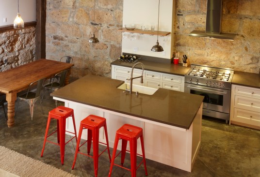 An impressive mix of materials work together in this kitchen:  Old stone, reclaimed fir, drywall, concrete, and Caesarstone