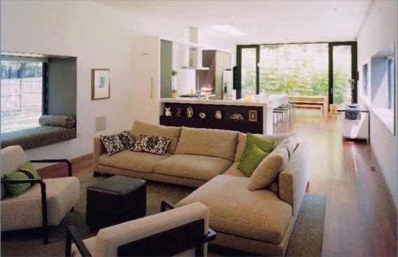 A cozy window seat graces the living room, which opens into a sunny kitchen and dining space.