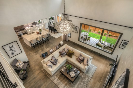 An open floor plan blurs the line between the living room, kitchen, and dining room at this Quadrant Homes property in Redmond, Washington.