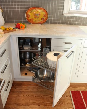 After shaking up the plan by moving walls, eliminating doors and enlarging the window, the new space was furnished with finely tailored cabinetry, quartzite tops and a custom built range hood as the focal point.