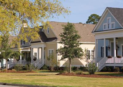 Oldfield's pastoral setting played a part in the designs, too. The homes in this second phase of development are oriented around a 60-foot-wide boulevard park lit with gas lanterns, a lake, sprawling live oaks, and a natural creek that meanders through the community.