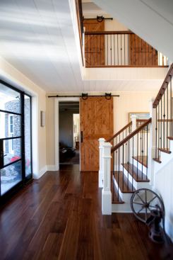 The foyer leads directly to the central circulation area and stairway, which is open on all sides to maintain sightlines from the front of the house to the back and to allow light to penetrate throughout.