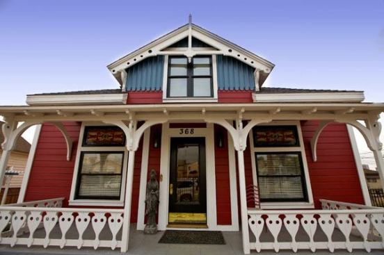 Part of a whole-house renovation, this kitchen and adjacent laundry room injected bold color and space-saving functionality into a challenging footprint.
