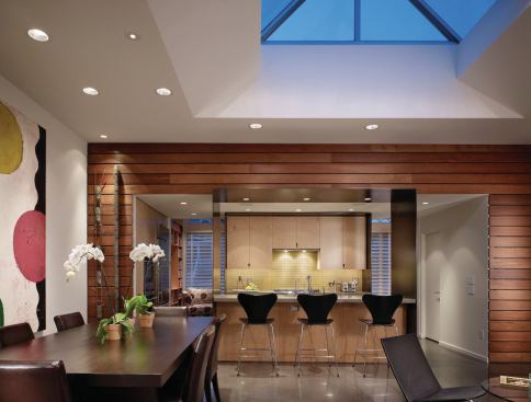 View from the dining and living room to the kitchen and the storefront foyer/office beyond at Madrona Live/Work, Seattle.