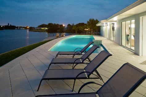 The lap pool adds strong design elements, while complementing the shape of the home and the lot.