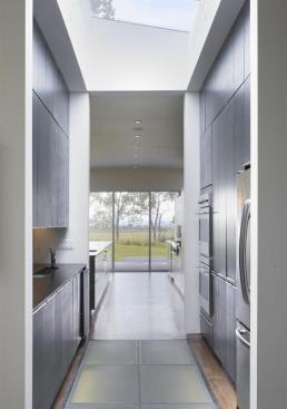 The pantry's glass floor panels transmit light to the house's lower level.