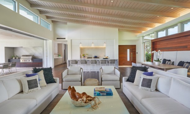 The simple shed roof provides a high-volume main living space and minimizes the house’s scale from the street and opens to a large lanai and the golf course and ocean beyond.