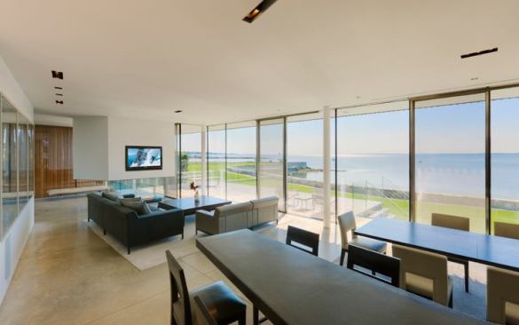 By juxtaposing projective and radial geometries, the house frames the scenery of its landscape, and its interior spaces flow into one another in a spiral that relates private to public and interior to exterior. The house's center also is the center of the spiral.