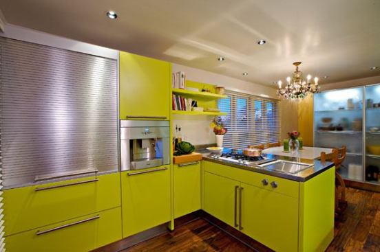 Unique storage solutions include a roll-up small appliance garage in anodised aluminum that also provides a pull-out breakfast bar and additional work surface.