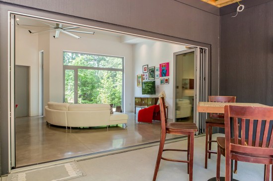 By eliminating the wall between the living/dining area and the back porch, the living space is extended into the outdoors.