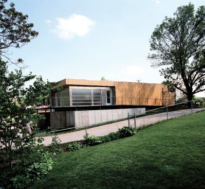 Sustainable materials like FSC-certified cypress siding, recycled flooring, and reused channel glass add a green dimension to the project.