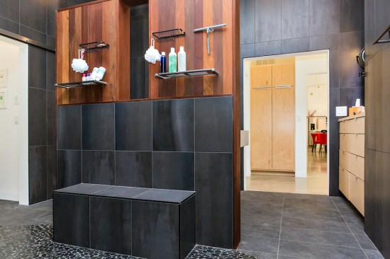 Ipe wood is a warm counterpoint in the Serdars' open double shower.