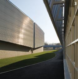 The metal skin on the side of the gym is the same as that used on the outside of the corridor it faces -- just rotated 90 degrees.