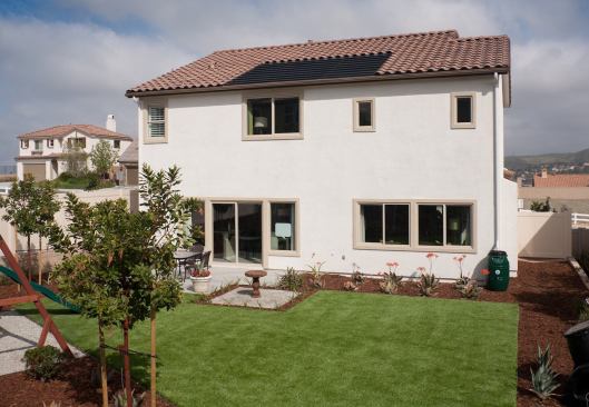 The Plan One model in the Santa Clarita, Calif., development features 100% artificial turf, a compost station, a vegetable garden, and a rain barrel.