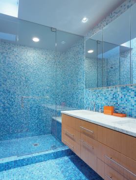 The bathrooms, including the master bath pictured here, boast a simple slate of materials.