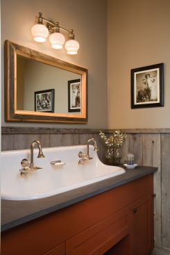 Trim elements made from raw wood are in the wainscot in the guest bath as well. This judicious addition of rough materials gives the contemporary design some Old West texture.