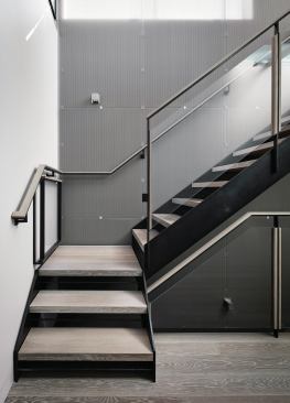 The metal screen wraps the stairwell wall down to the entryway.
