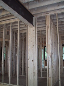 Don't create butt joints on built-up carrying posts like these (above). Instead, position drywall sheets to span over those posts (below).