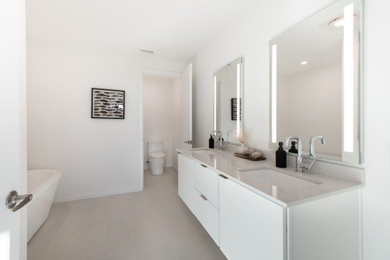 Master baths in each of the units are outfitted with dual vanities, walk-in showers, and soaking tubs.