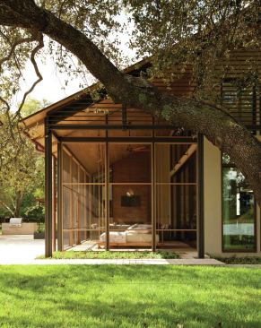 The screened porch and living room face south on a spit of land overlooking Lake Austin.