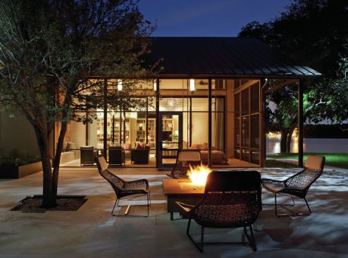 The screened porch adjoins a patio and fire pit