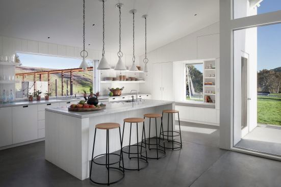 White interiors, open shelving, and ample daylight allow the small floor plan to live large. 