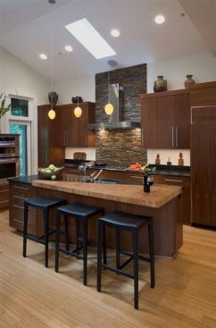 Jennifer Gilmer Kitchen & Bath designed this low- to mid-range kitchen with an Asian influence and environmentally friendly products. It features walnut veneer cabinets, bamboo countertops, and stone tiles.