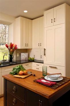 This mid- to high-range has a clean and simple Asian feel with white cabinets. The black island is topped with a teak countertop and enhanced Asian-style hardware. 