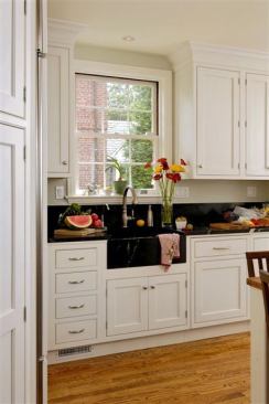 The client for this low- to mid-range kitchen wanted a traditional “butler’s pantry” feel so Jennifer Gilmer Kitchen & Bath used painted white inset cabinets. A soapstone countertop and soapstone farmhouse style sink add to the historical feel.
