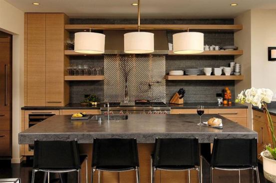 This high-end contemporary kitchen features open shelving, a thick concrete top, and end panels with cabinets sandwiched between. It won first place in a local Sub Zero design contest.

