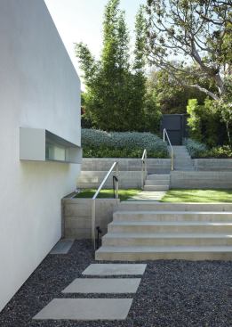 From the front gate, the entry path descends to a sunken patio. 
