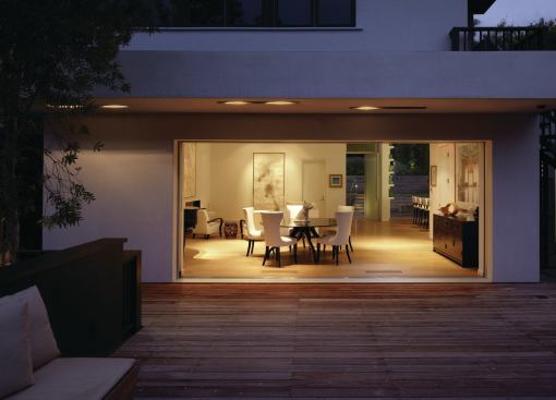The alley-facing garage is a full story below the living spaces. Its roof doubles as a deck off the dining area. 