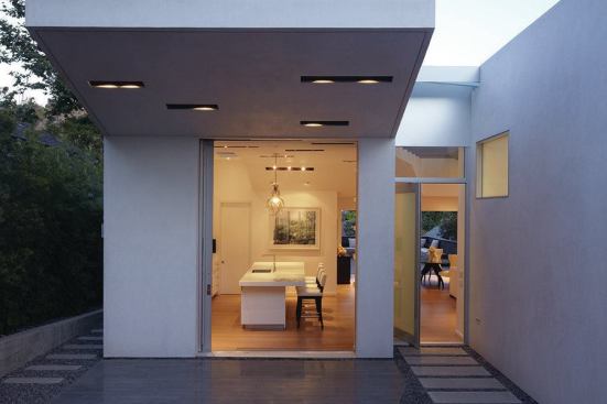 This remodel organizes the house around a pathway that angles through the 50-foot-wide lot