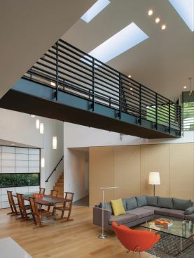 A steel bridge spans the living and dining area at the center of the first floor plan.