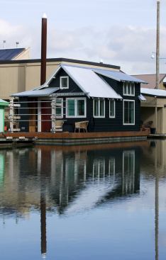 A corrugated metal roof and cedar channel siding befit the nautical setting.