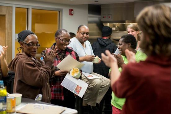 Residents enjoy soup and camaraderie in the kitchen.