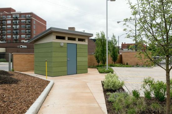 The garden shed is clad in colorful fiber-cement panels.