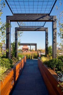 From the service entrance, ipe planters and a small pergola beckon visitors into the garden. The existing vent stacks, painted black, tag this as an urban space.