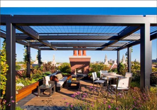 Grapevines growing on the larger pergola will eventually shade part of the seating area. Here, the thin slate pathways, manufactured for roof decks, become a border inset with ipe, like a rug. 